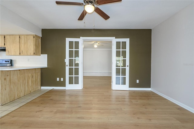 kitchen featuring french doors, light wood-type flooring, tasteful backsplash, and light brown cabinetry