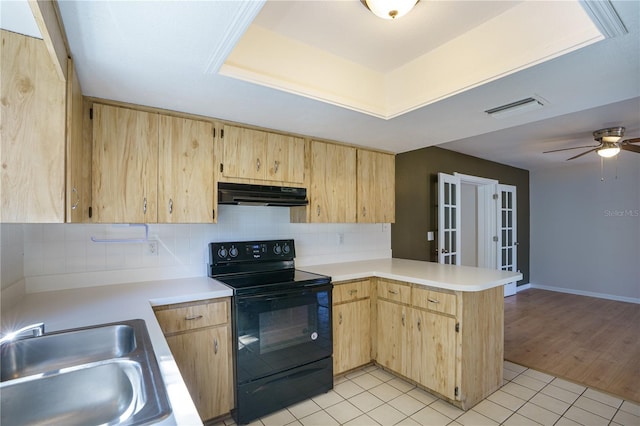 kitchen with kitchen peninsula, black range with electric stovetop, sink, and light tile patterned floors