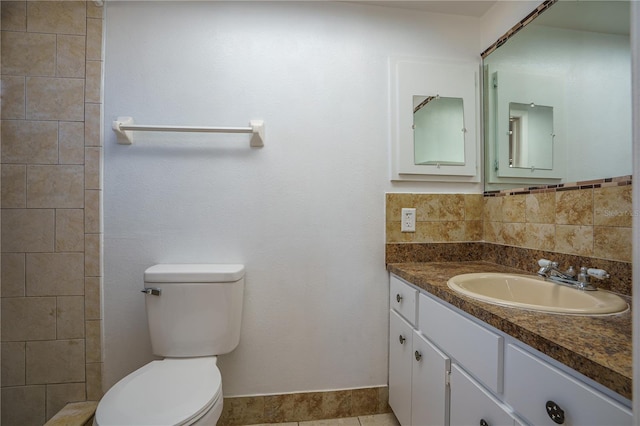 bathroom featuring tile patterned floors, vanity, and toilet