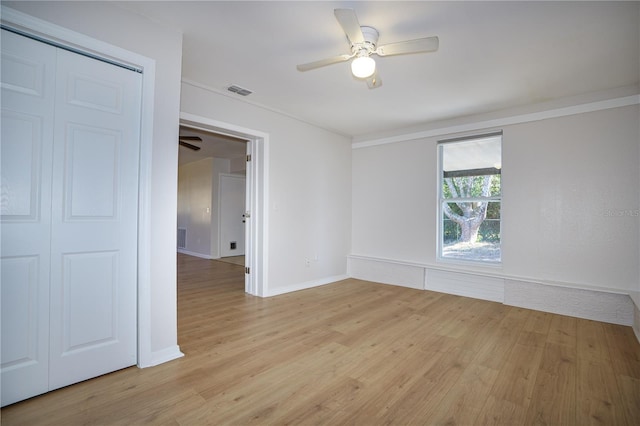 spare room with ceiling fan and light wood-type flooring