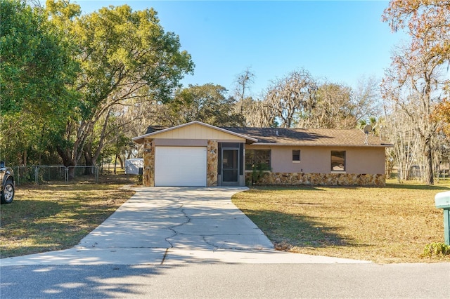 ranch-style home with a garage and a front yard