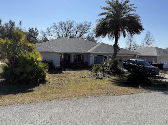 single story home with a front lawn