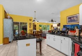 kitchen featuring white cabinetry, light tile patterned floors, a breakfast bar area, and a kitchen island