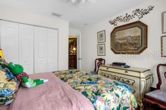 bedroom with ceiling fan and a closet