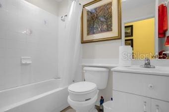 full bathroom with vanity, tub / shower combination, and toilet