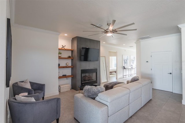 living room featuring a fireplace, ceiling fan, and ornamental molding