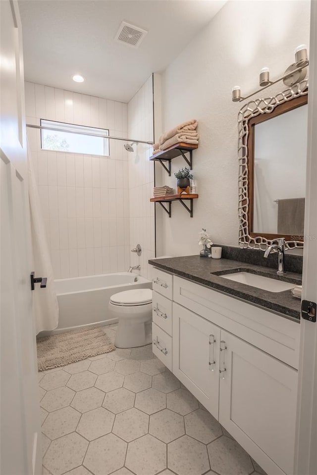 full bathroom with vanity, shower / bath combination with curtain, and toilet