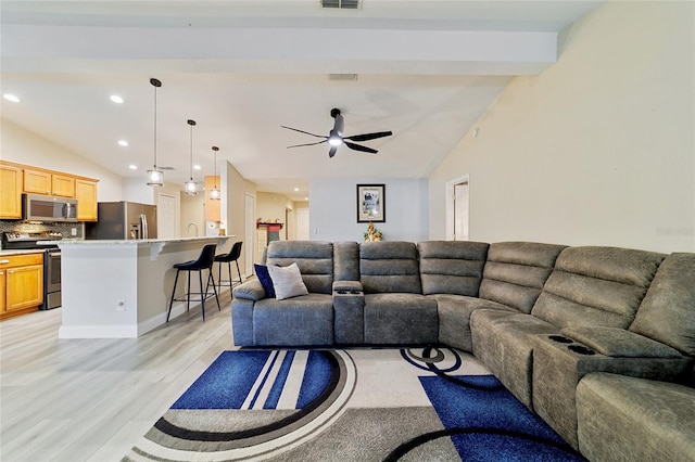 living room with lofted ceiling with beams, ceiling fan, and light hardwood / wood-style flooring