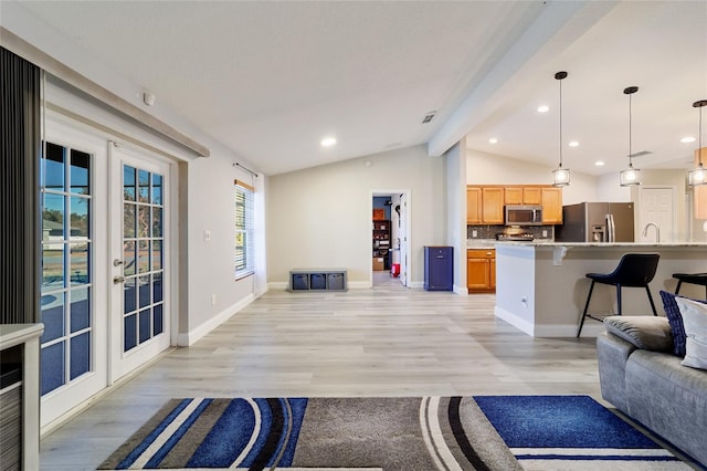 living room with french doors, light hardwood / wood-style flooring, and vaulted ceiling with beams