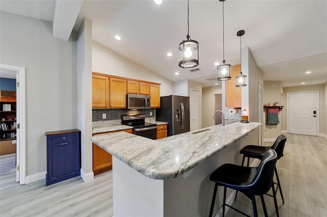 kitchen with sink, vaulted ceiling, kitchen peninsula, hanging light fixtures, and appliances with stainless steel finishes