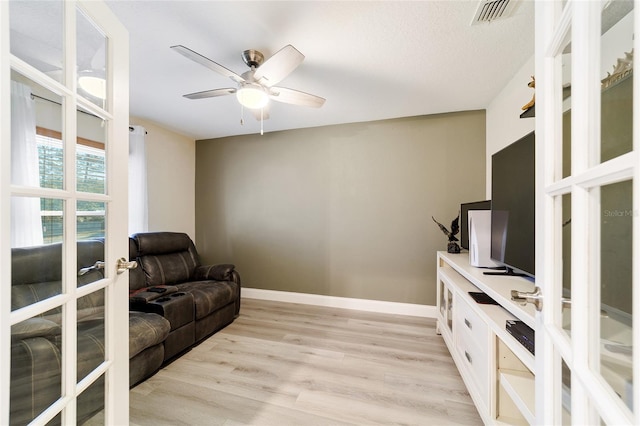 interior space featuring ceiling fan, light wood-type flooring, and french doors