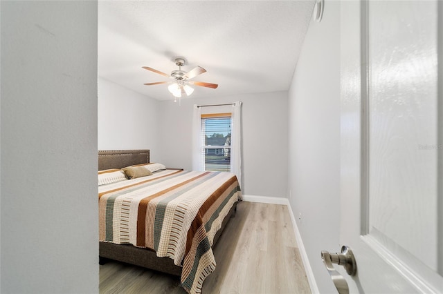 bedroom with ceiling fan and light hardwood / wood-style floors