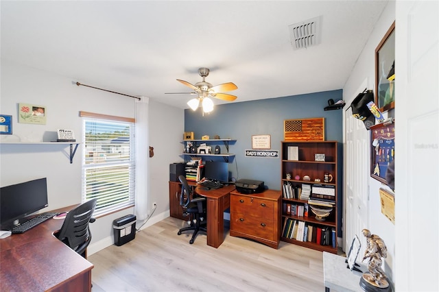 office area with light wood-type flooring and ceiling fan