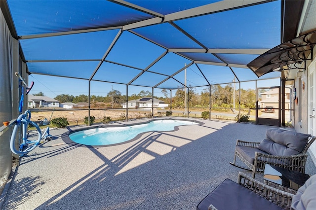 view of pool with a lanai and a patio area