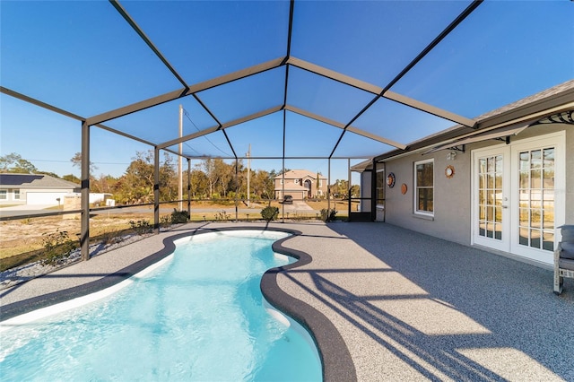 view of swimming pool with french doors, a patio area, and glass enclosure