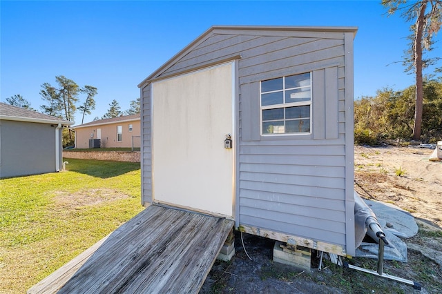 view of outdoor structure with a yard and cooling unit