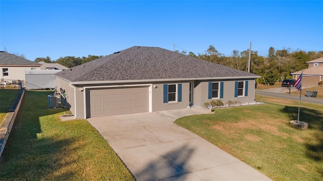 ranch-style home featuring a garage, a front lawn, and central AC unit