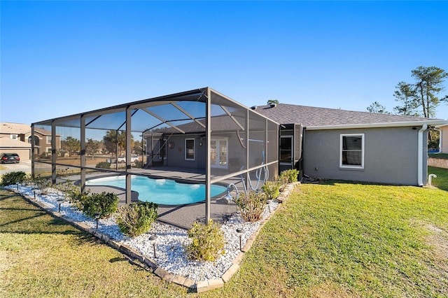 view of swimming pool featuring a lawn, glass enclosure, and a patio