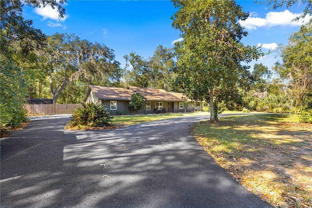 ranch-style home with a front lawn