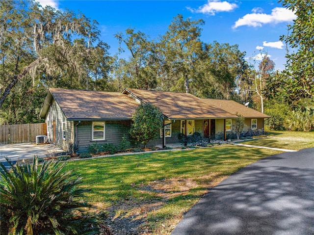 ranch-style house with a front yard, central AC, and a porch