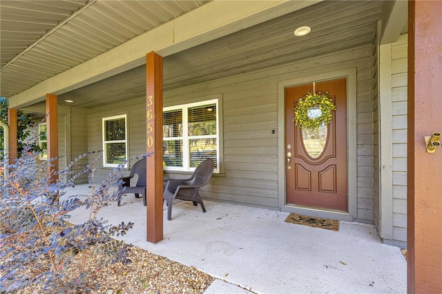 view of exterior entry with a porch