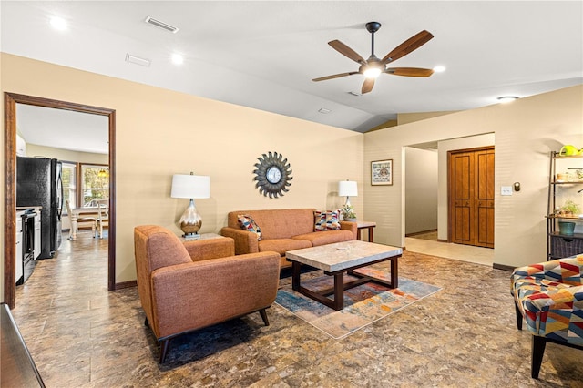 living room with ceiling fan and vaulted ceiling