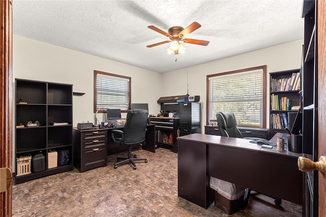 office with a textured ceiling and ceiling fan