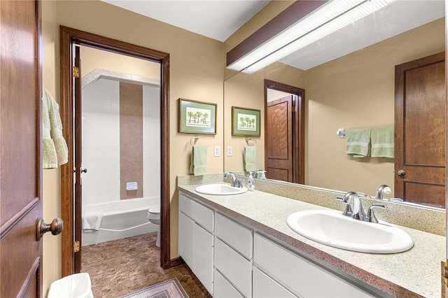 full bathroom with toilet, vanity, and tiled shower / bath