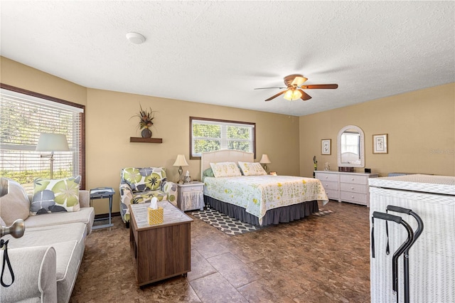 bedroom featuring a textured ceiling and ceiling fan