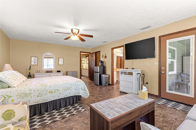 bedroom featuring stainless steel refrigerator, a textured ceiling, ceiling fan, and access to exterior