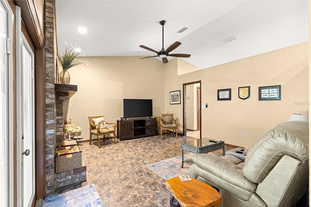 living room with lofted ceiling, a fireplace, and ceiling fan