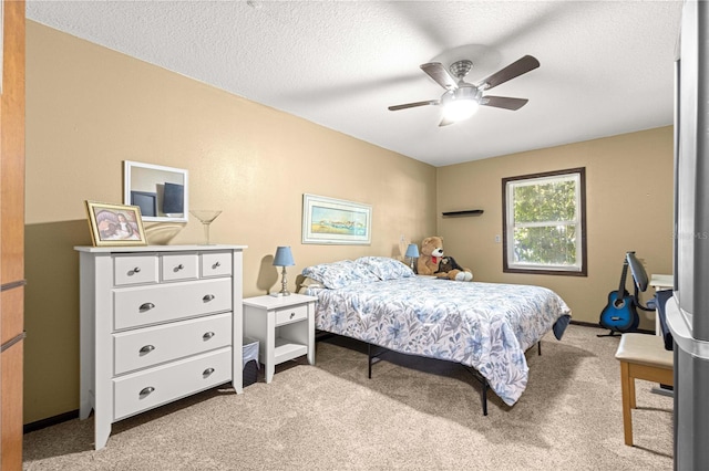 carpeted bedroom featuring a textured ceiling and ceiling fan