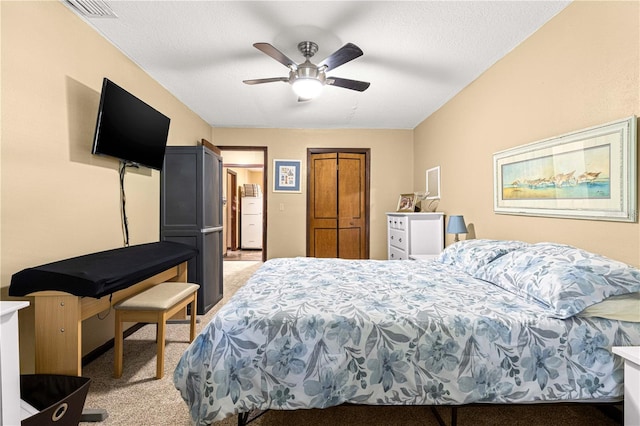 carpeted bedroom with a textured ceiling and ceiling fan