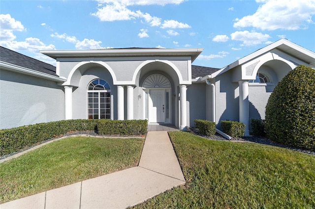 entrance to property with a yard