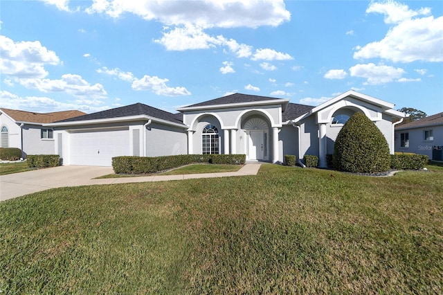 view of front of house with a front yard and a garage