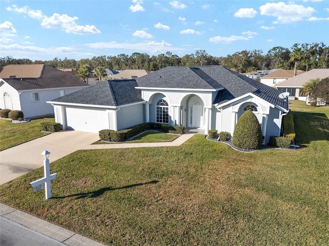 single story home featuring a garage and a front lawn