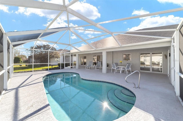 view of pool featuring glass enclosure and a patio