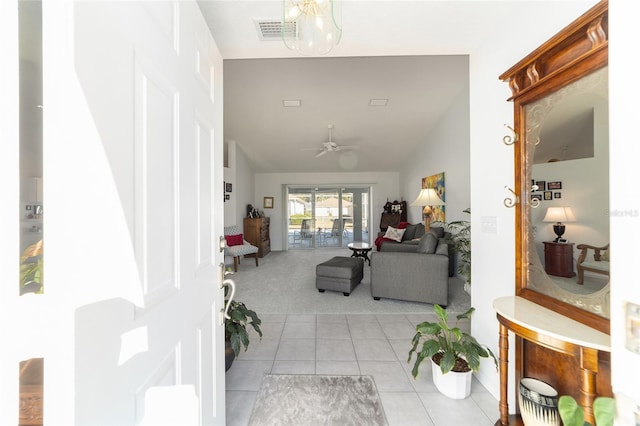 hall with light tile patterned floors and vaulted ceiling