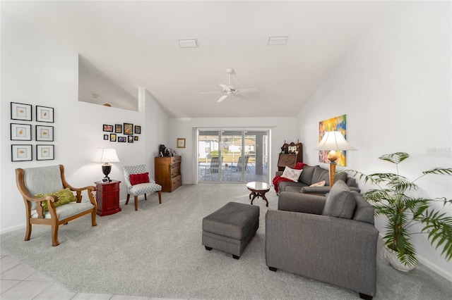 tiled living room with ceiling fan and high vaulted ceiling