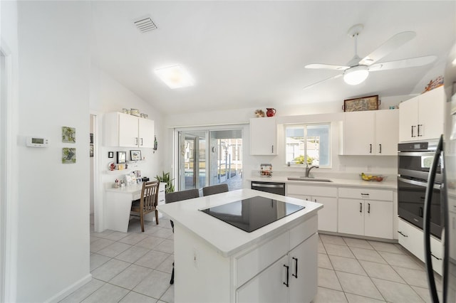 kitchen featuring white cabinetry, a center island, and appliances with stainless steel finishes