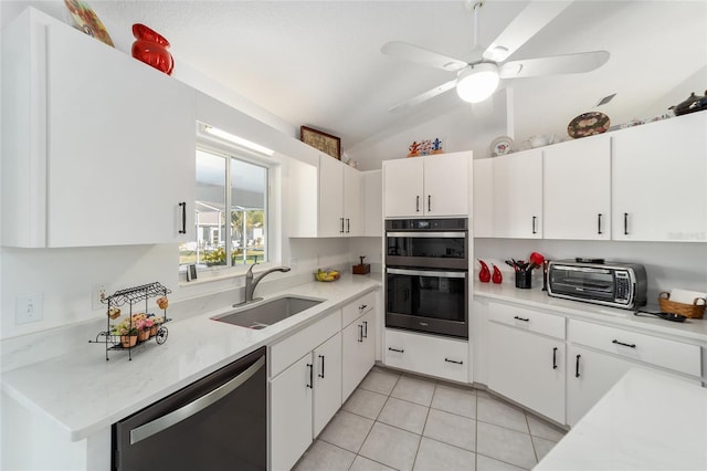 kitchen with white cabinetry, sink, stainless steel appliances, lofted ceiling, and light tile patterned floors