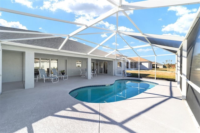 view of pool with a patio area and a lanai