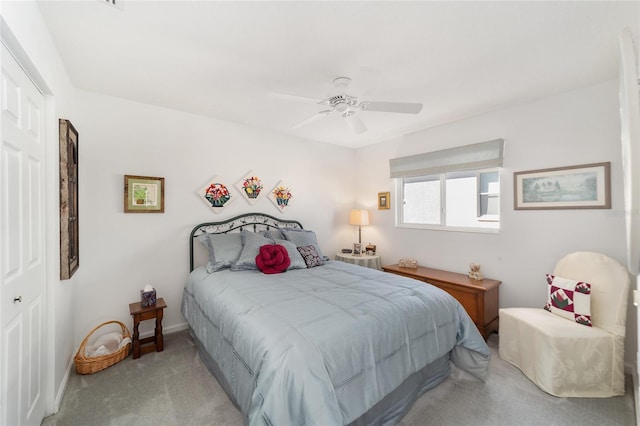 carpeted bedroom with ceiling fan and a closet