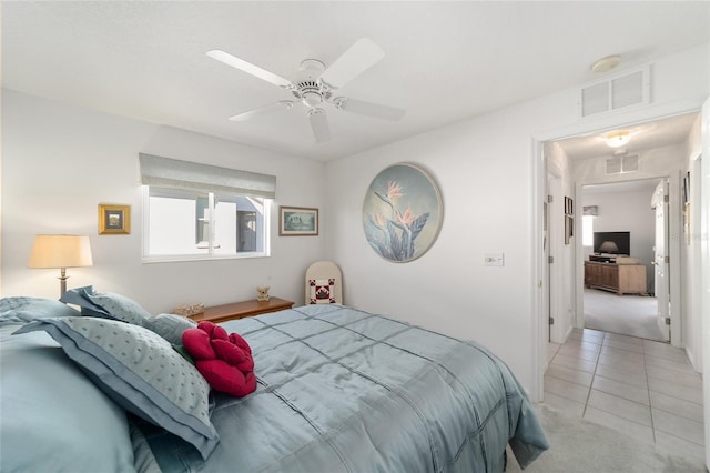 tiled bedroom featuring ceiling fan