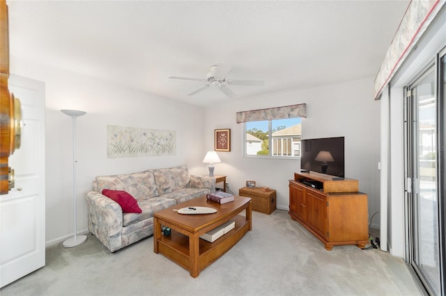 carpeted living room featuring ceiling fan