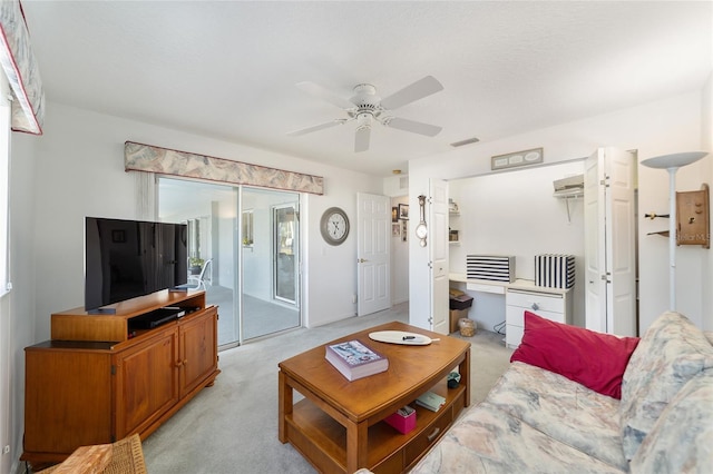 carpeted living room with ceiling fan