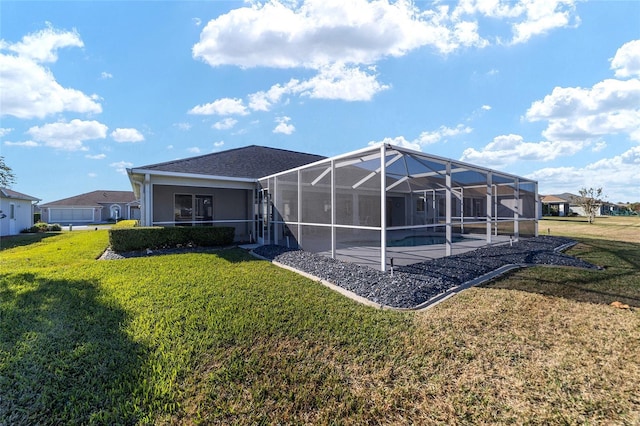 back of property with a lanai, a patio area, and a lawn