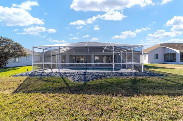 back of property featuring glass enclosure and a lawn