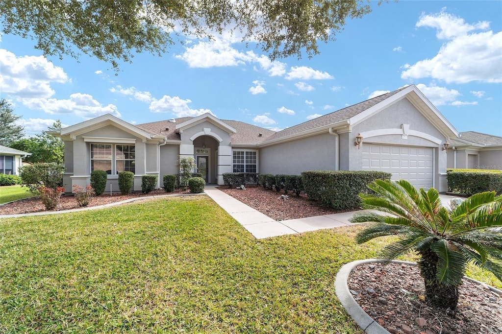 ranch-style home featuring a front lawn and a garage