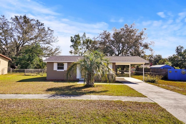 single story home featuring a front yard and a carport